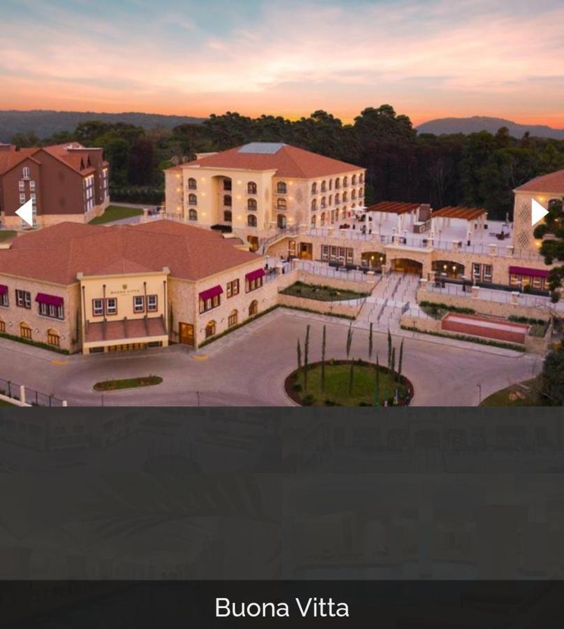 Buona Vitta Gramado Resort & Spa By Gramado Parks ภายนอก รูปภาพ The image shows a large, modern building complex, likely a hotel or resort. The architecture features a combination of traditional and contemporary design elements. Surrounding the main building are landscaped areas, including trees and green spaces,